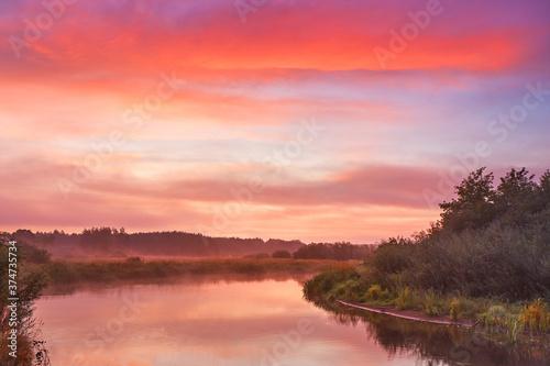 Obraz na płótnie Fog over lake, Colorful dawn. Cloudy sunrise. Dusk fall colors. w salonie