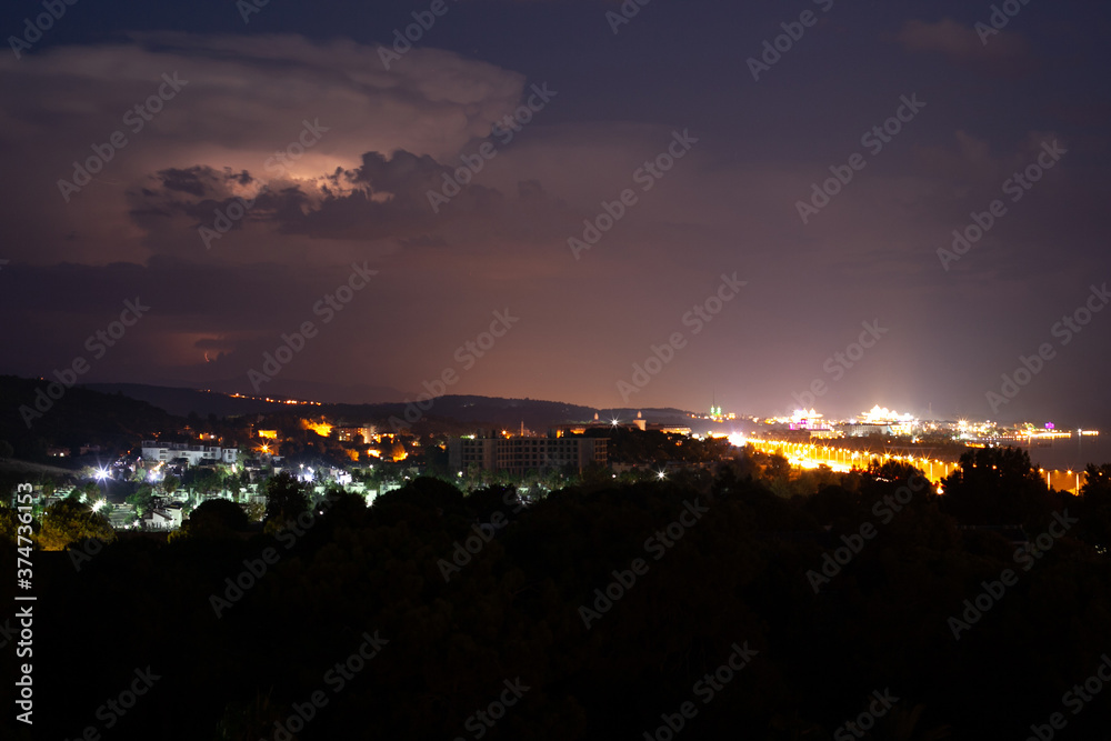 Lightning flashes in the night sky before the start of a thunderstorm, city, Turkey