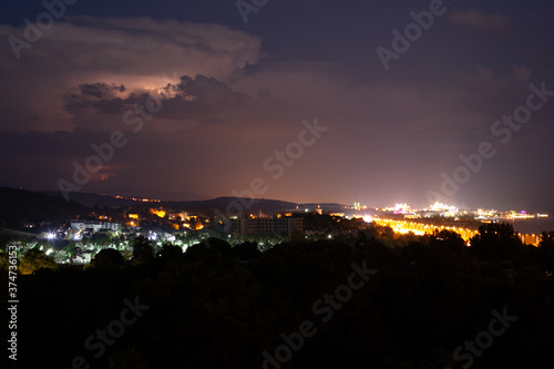 Lightning flashes in the night sky before the start of a thunderstorm, city, Turkey