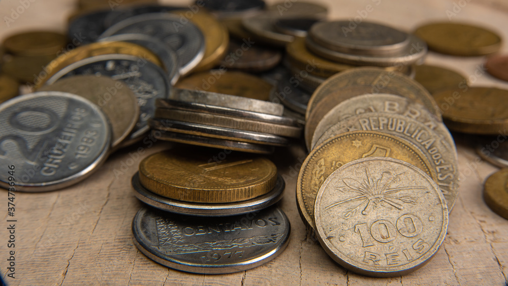 Old coins placed on a rustic wooden platform, selective focus Old coins placed on a rustic wooden platform, selective focus