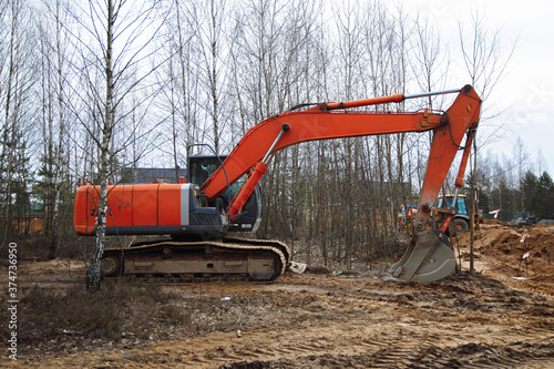 excavator and bulldozer at work on a construction quarter