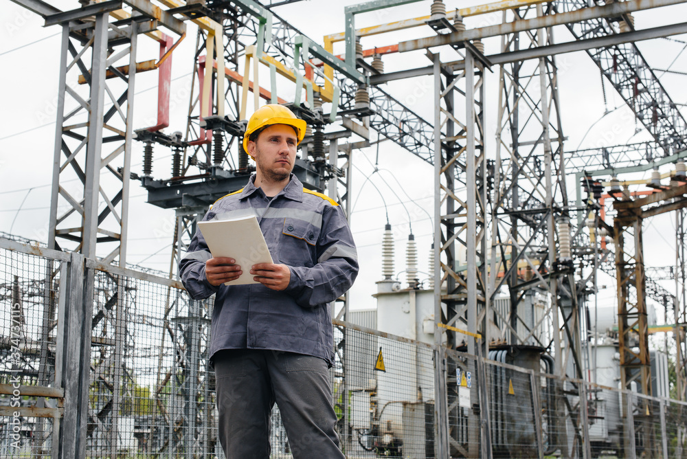 The energy engineer inspects the equipment of the substation. Power engineering. Industry The energy engineer inspects the equipment of the substation. Power engineering. Industry