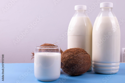 coconut lactose free milk in plastic bottles on blue surface