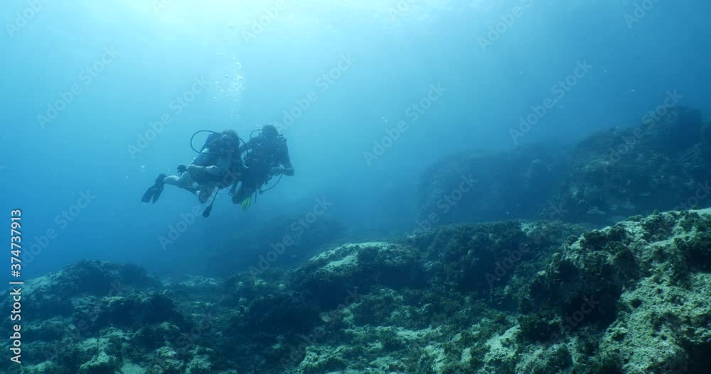 beginner scuba divers learning to dive in blue water underwater scenery of a lady and teacher beginner scuba divers learning to dive in blue water underwater scenery of a lady and teacher