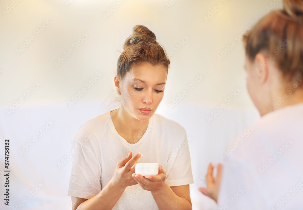 Magic anti-aging cream.Applying the cream. woman moisturizing face mask. Cosmetology and skin care concept. Magic anti-aging cream.Applying the cream. woman moisturizing face mask. Cosmetology and skin care concept.