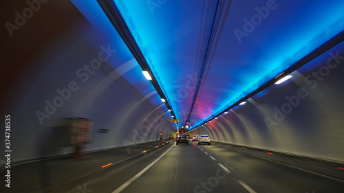  fast-moving cars and highway inside the traffic tunnel