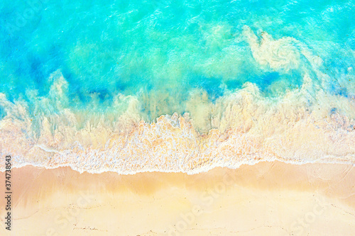 Top view aerial drone photo of ocean seashore with beautiful turquoise water and foam sea waves. Caribbean resort. Vacation travel background.