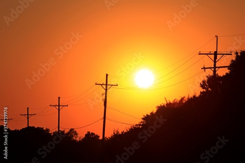 power lines at sunset with a colorful sky in Kansas.