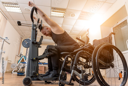 Disabled man training in the gym. Rehabilitation center