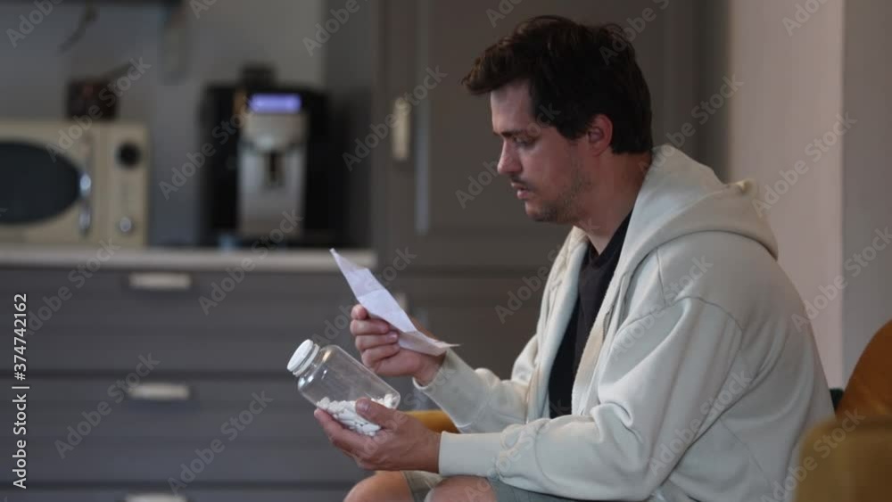 sick man reads prescriptions on how to take pills sick man reads prescriptions on how to take pills