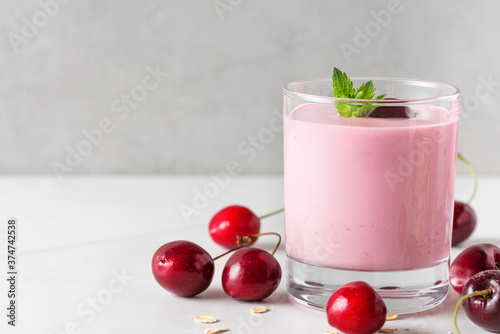 Wallpaper Mural Cherry yogurt with fresh berries and mint in a glass on white background. Healthy diet breakfast Torontodigital.ca