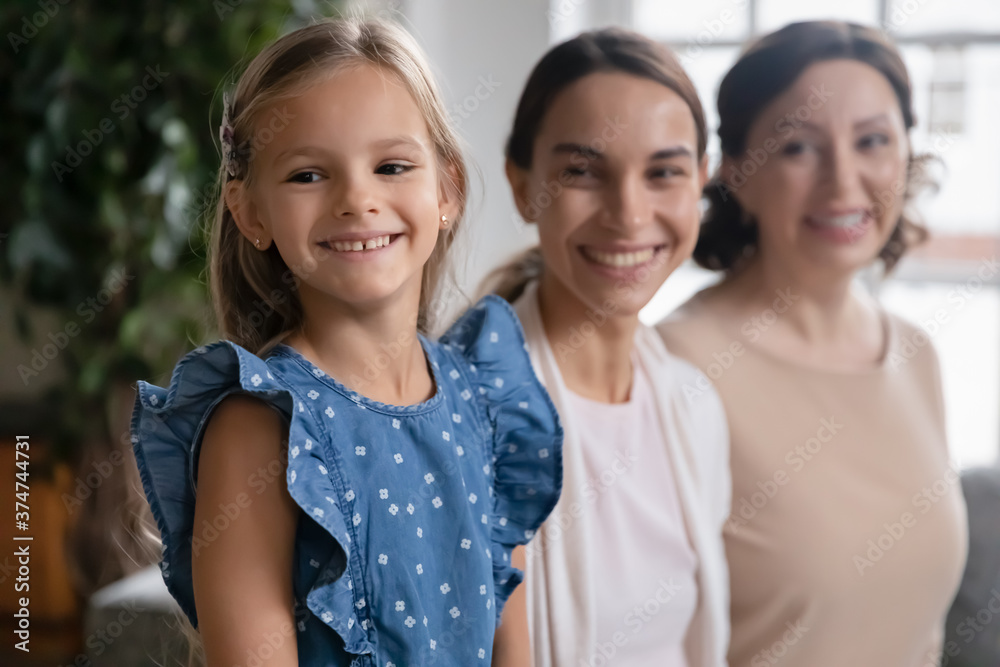 Happy beautiful three generations women looking away, visualizing good future. Smiling small adorable child girl dreaming with beautiful young mother and cheerful older senior granny at home. Happy beautiful three generations women looking away, visualizing good future. Smiling small adorable child girl dreaming with beautiful young mother and cheerful older senior granny at home.
