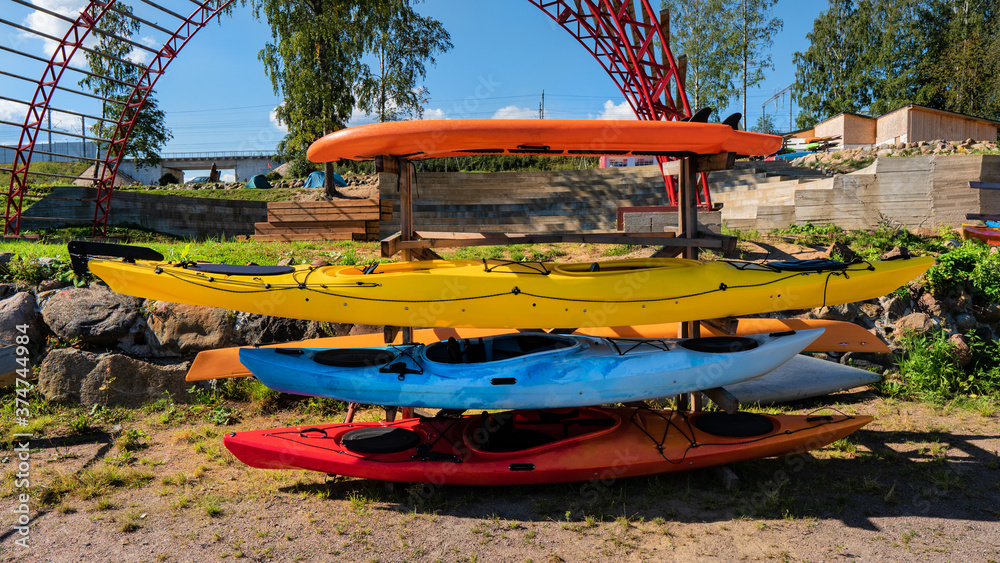 multicolored kayaks stacked on a rack