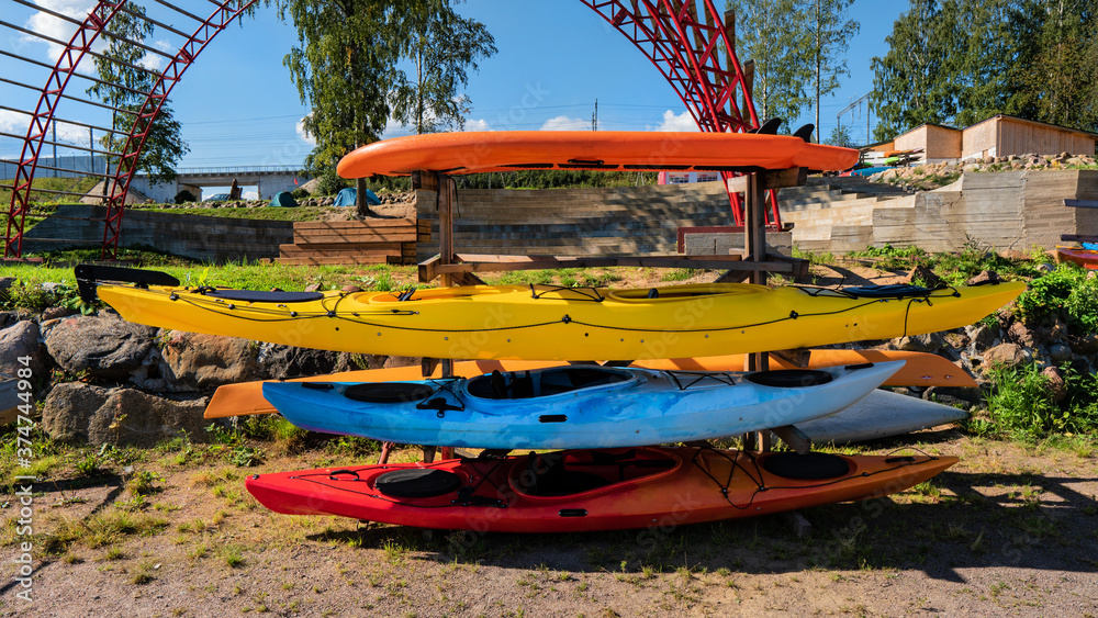 multicolored kayaks stacked on a rack multicolored kayaks stacked on a rack