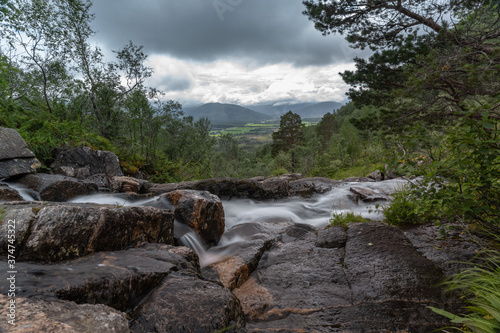 Beautiful waterfalls and stunning views along the hike to Trollkirka (Troll church) cave, a marble and limestone cave with underground rivers and waterfalls, Elnesvsgen, Romsdal, Norway. photo