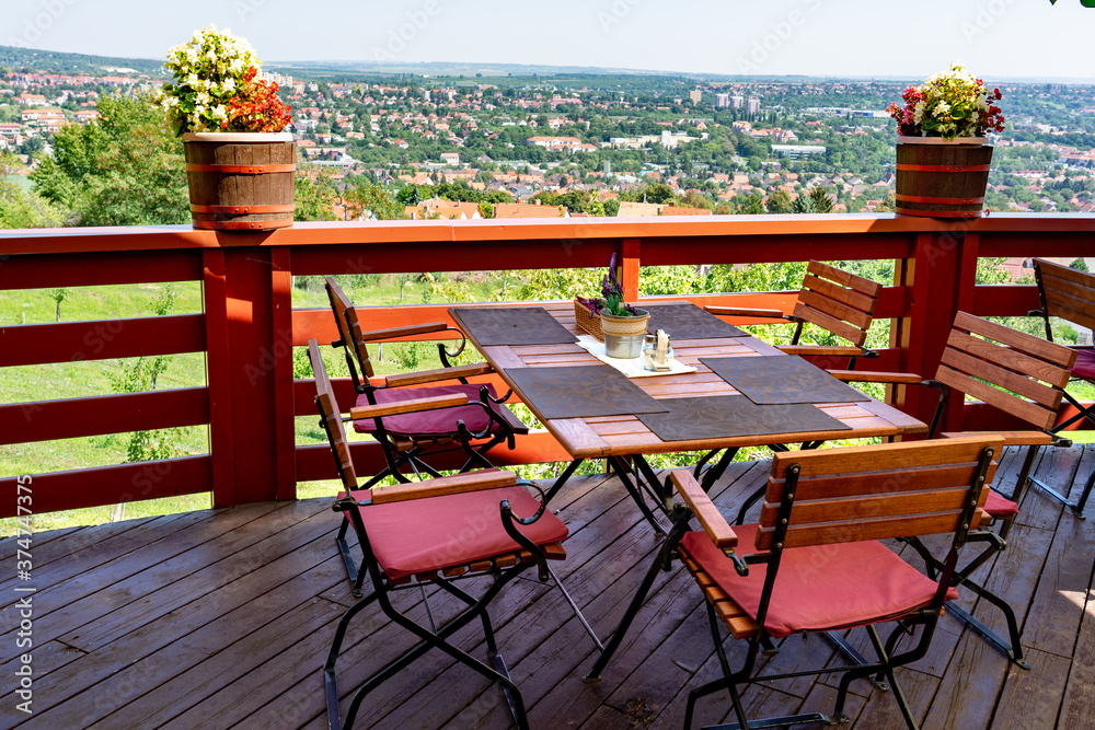 Fototapeta premium classic terrace furniture with beautiful view of city Pecs in Hungay