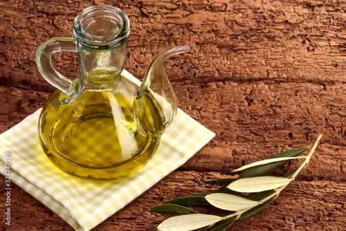 Extra virgin olive oil in a rustic glass jar photo