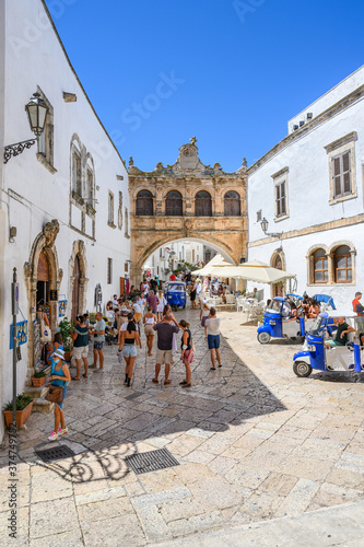 Fototapeta Naklejka Na Ścianę i Meble -  Ostuni, Bari, Italy - 
People walking in Ostuni, also called the white city