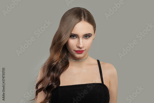 Beautiful young female model woman with brown curly hair on white