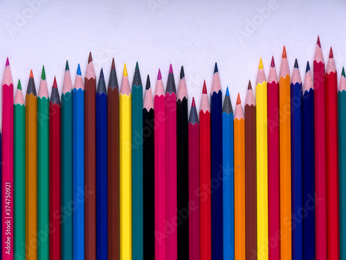 School supplies on blackboard background ready for your design. back to school. colourful crayons. colorful background