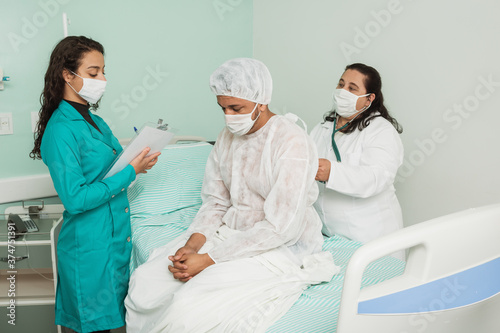 doctor diagnosing patient and nurse writing down diagnosis