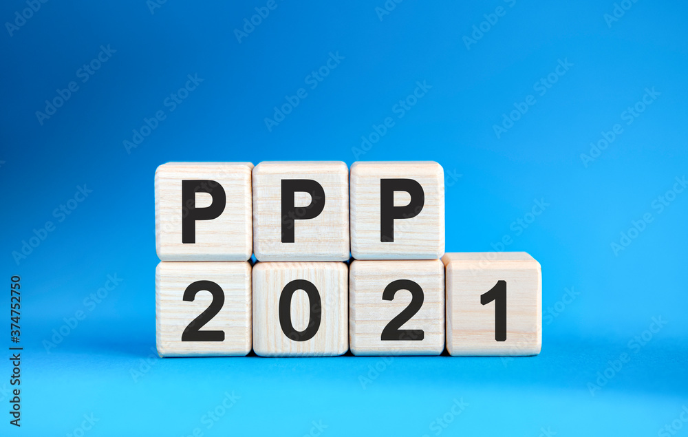 PPP 2021 years on wooden cubes on a blue background PPP 2021 years on wooden cubes on a blue background