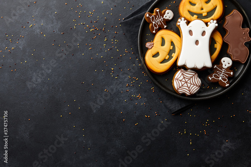 Funny Halloween gingerbread biscuits on black background