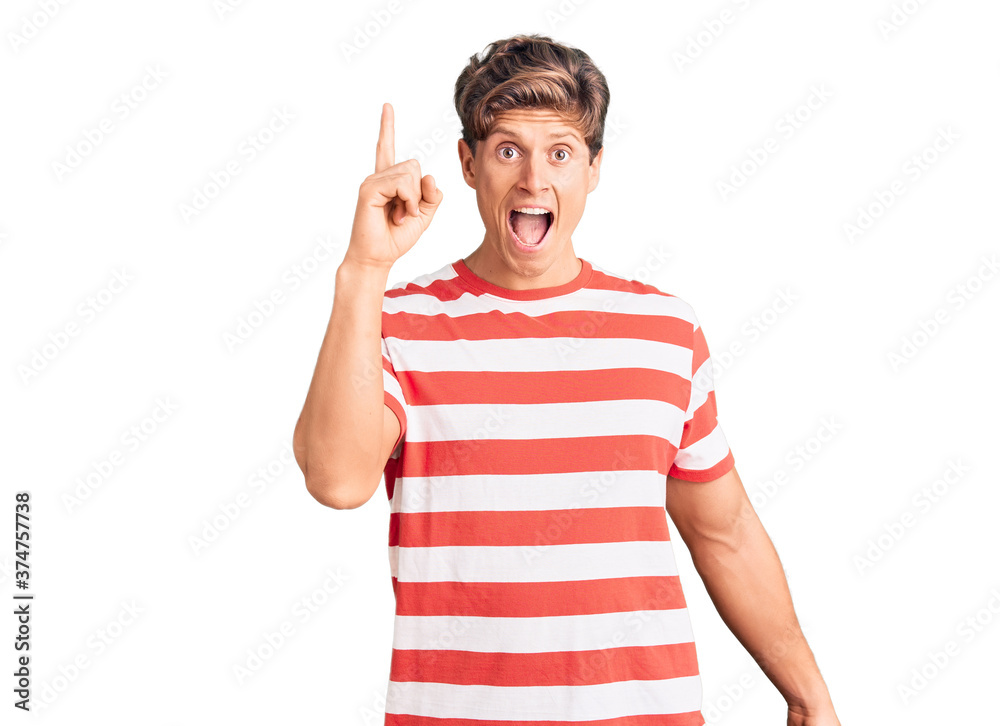 Young handsome man wearing casual clothes pointing finger up with successful idea. exited and happy. number one. Young handsome man wearing casual clothes pointing finger up with successful idea. exited and happy. number one.