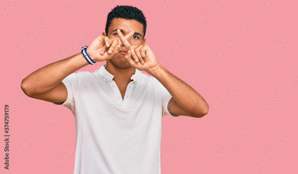 Young arab man wearing casual clothes rejection expression crossing fingers doing negative sign