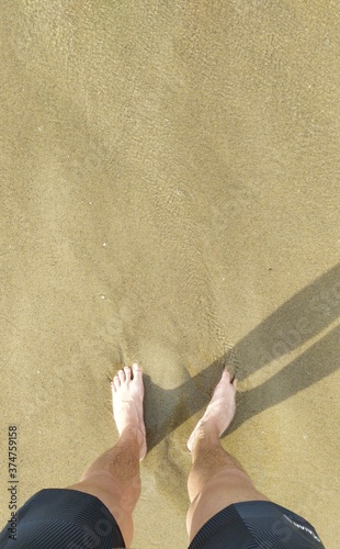 Barefoot in clear water on the beach