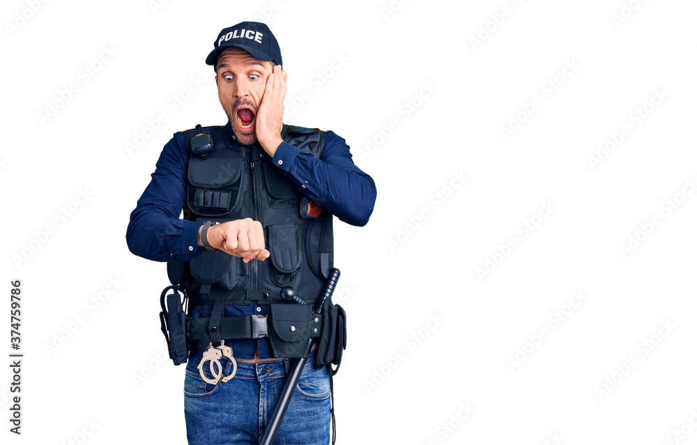 Young handsome man wearing police uniform looking at the watch time worried, afraid of getting late Young handsome man wearing police uniform looking at the watch time worried, afraid of getting late