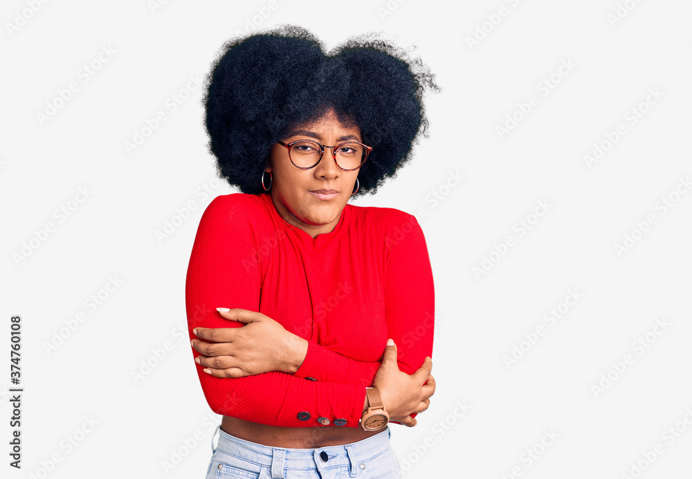 Young african american girl wearing casual clothes and glasses shaking and freezing for winter cold with sad and shock expression on face Young african american girl wearing casual clothes and glasses shaking and freezing for winter cold with sad and shock expression on face