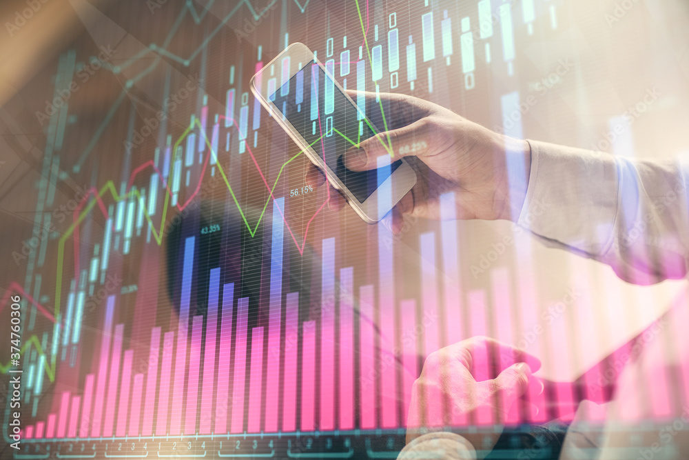 Double exposure of man's hands holding and using a digital device and forex graph drawing. Financial market concept. Double exposure of man's hands holding and using a digital device and forex graph drawing. Financial market concept.