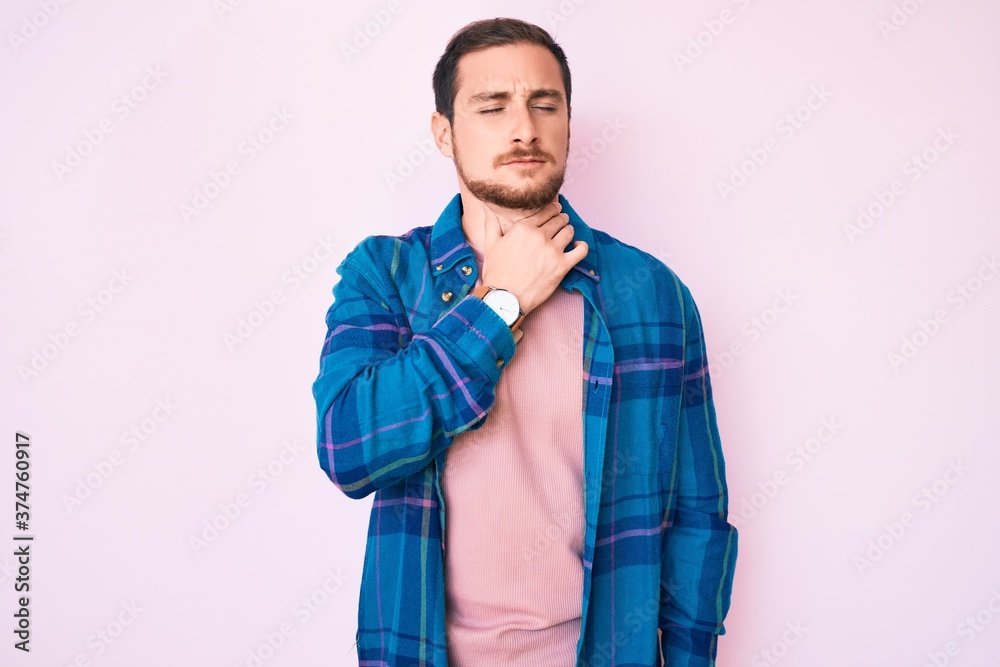 Young handsome man wearing casual clothes touching painful neck, sore throat for flu, clod and infection Young handsome man wearing casual clothes touching painful neck, sore throat for flu, clod and infection