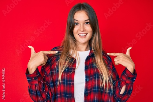 Beautiful caucasian woman wearing casual clothes looking confident with smile on face, pointing oneself with fingers proud and happy.