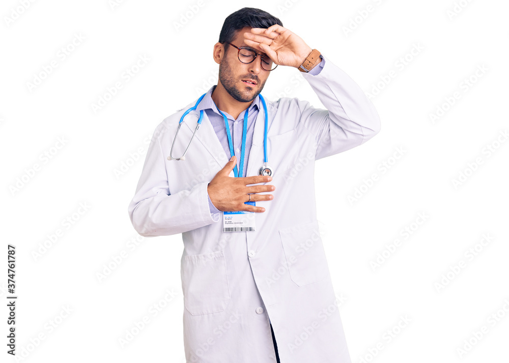 Young hispanic man wearing doctor uniform and stethoscope touching forehead for illness and fever, flu and cold, virus sick Young hispanic man wearing doctor uniform and stethoscope touching forehead for illness and fever, flu and cold, virus sick