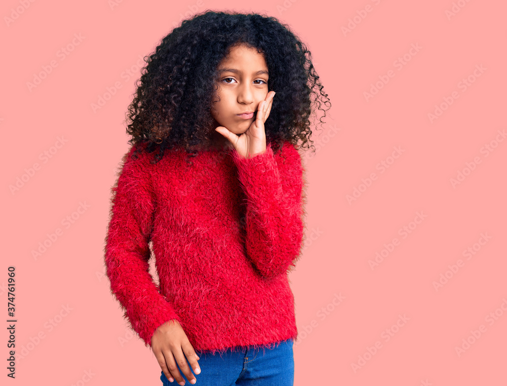 African american child with curly hair wearing casual winter sweater thinking looking tired and bored with depression problems with crossed arms. African american child with curly hair wearing casual winter sweater thinking looking tired and bored with depression problems with crossed arms.
