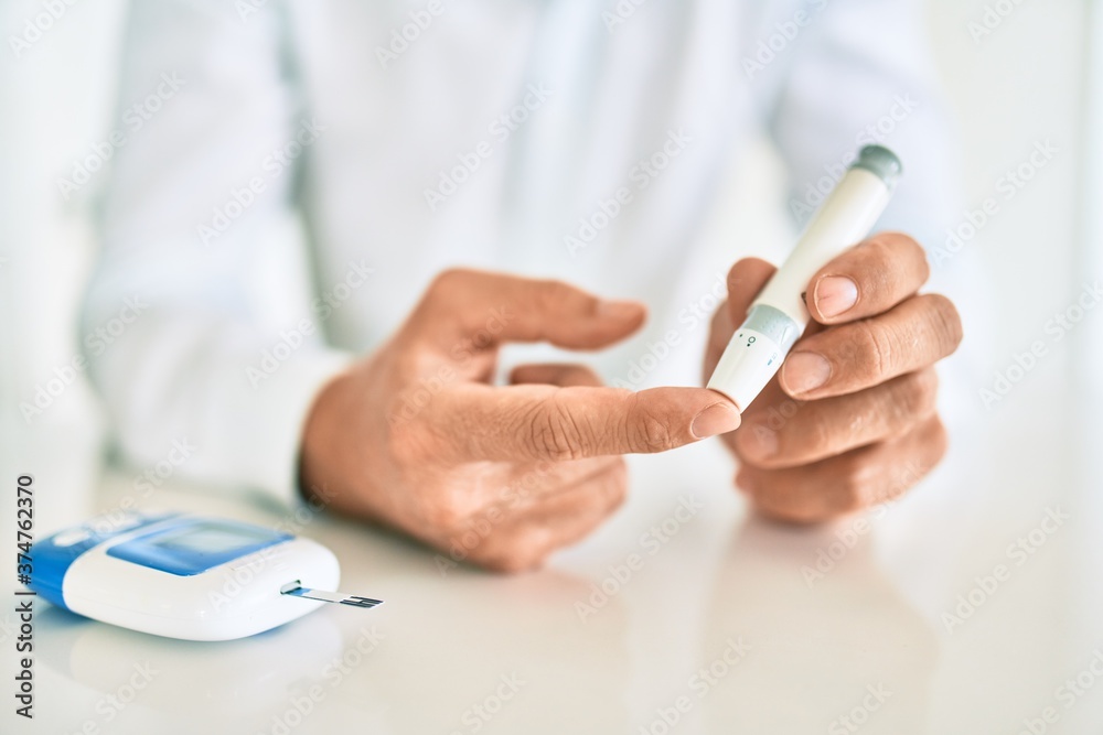 Close up of man with diabetes using insuline stick with syringe Close up of man with diabetes using insuline stick with syringe