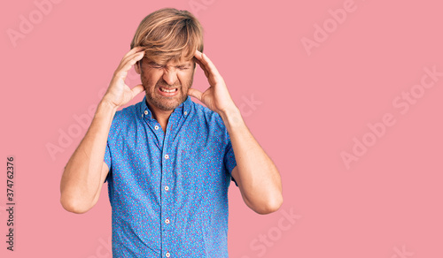 Fotografie Handsome caucasian man with beard wearing casual clothes suffering from headache desperate and stressed because pain and migraine