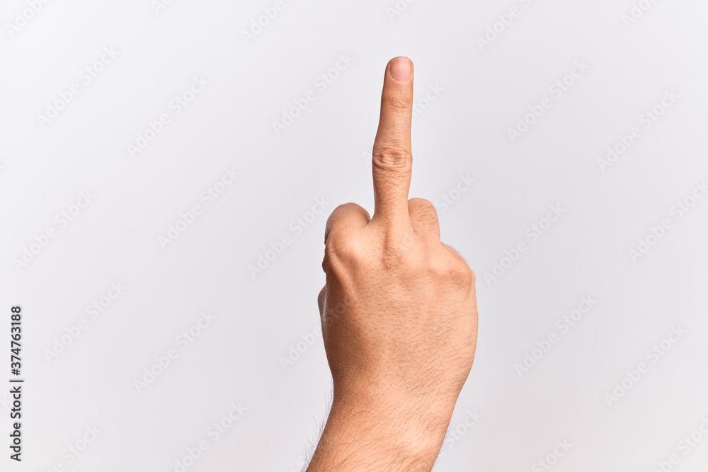 Hand of caucasian young man showing fingers over isolated white background showing provocative and rude gesture doing fuck you symbol with middle finger Hand of caucasian young man showing fingers over isolated white background showing provocative and rude gesture doing fuck you symbol with middle finger