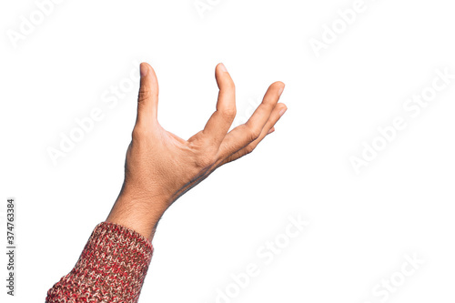 Hand of caucasian young man showing fingers over isolated white background picking and taking invisible thing, holding object with fingers showing space