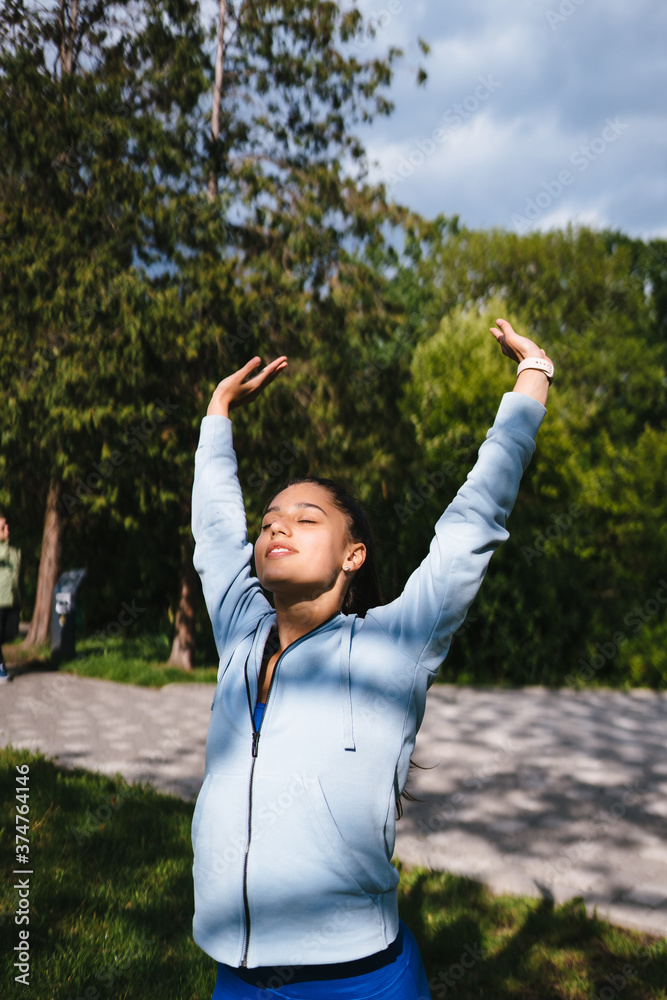 Girl in sports uniform warming up before jogging Girl in sports uniform warming up before jogging