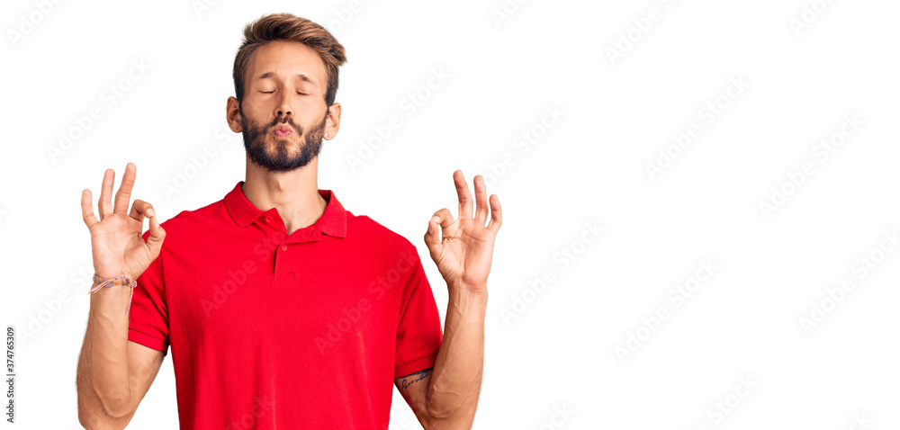 Handsome blond man with beard wearing casual clothes relax and smiling with eyes closed doing meditation gesture with fingers. yoga concept. Handsome blond man with beard wearing casual clothes relax and smiling with eyes closed doing meditation gesture with fingers. yoga concept.