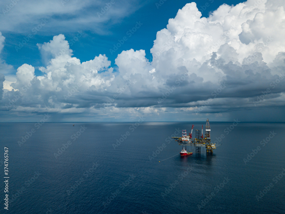 Aerial view from a drone of an offshore jack up rig at the offshore location during day time Aerial view from a drone of an offshore jack up rig at the offshore location during day time