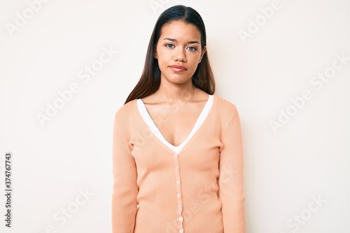 Young beautiful latin girl wearing casual clothes with serious expression on face. simple and natural looking at the camera. © Krakenimages.com
