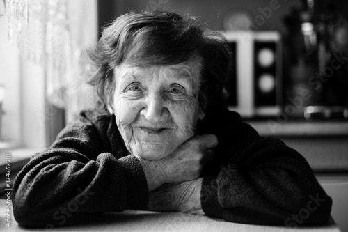 Black and white close-up portrait of old woman in her home. © De Visu