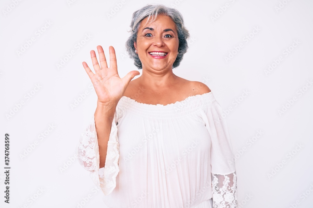 Senior hispanic grey- haired woman wearing casual clothes showing and pointing up with fingers number five while smiling confident and happy.