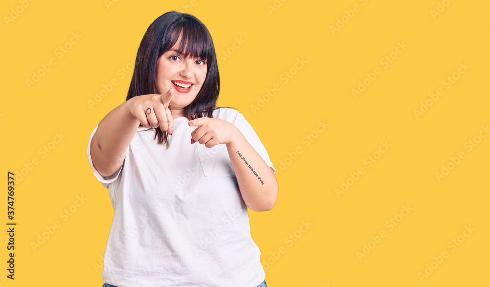 Young plus size woman wearing casual clothes pointing to you and the camera with fingers, smiling positive and cheerful Young plus size woman wearing casual clothes pointing to you and the camera with fingers, smiling positive and cheerful