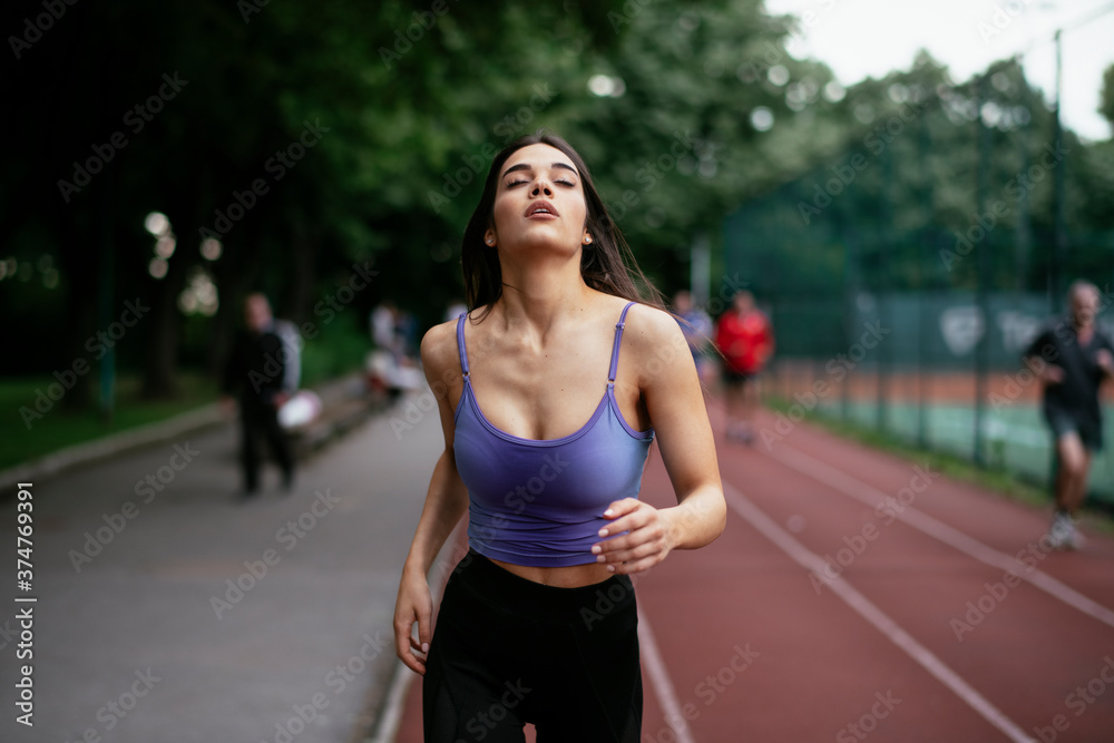 Happy athletic woman running in nature in the morning. Young woman training outdoors.... Happy athletic woman running in nature in the morning. Young woman training outdoors....