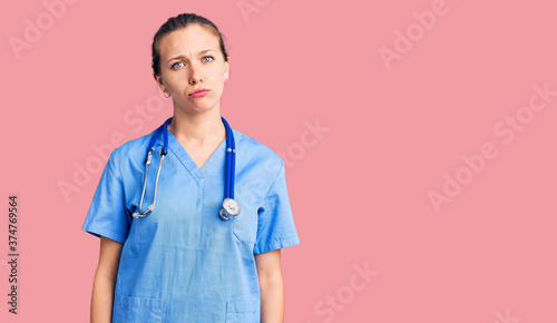 Young beautiful blonde woman wearing doctor uniform and stethoscope depressed and worry for distress, crying angry and afraid. sad expression.